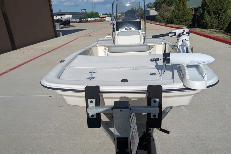 Slide: The Image of 2026 Mako Pro Skiff 13 CC boat on trailer, parked outdoors in sunny setting. - 5