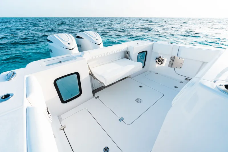 Slide: The Image of 2027 Sportsman Open 302 Center Console boat with dual engines on open sea. - 19