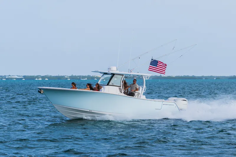 Slide: The Image of 2027 Sportsman Open 302 Center Console boat cruising on ocean with American flag. - 1