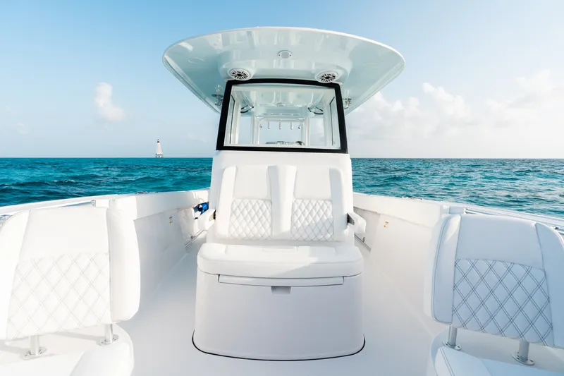 Slide: The Image of 2027 Sportsman Open 302 Center Console boat on open sea, featuring sleek white seating. - 7