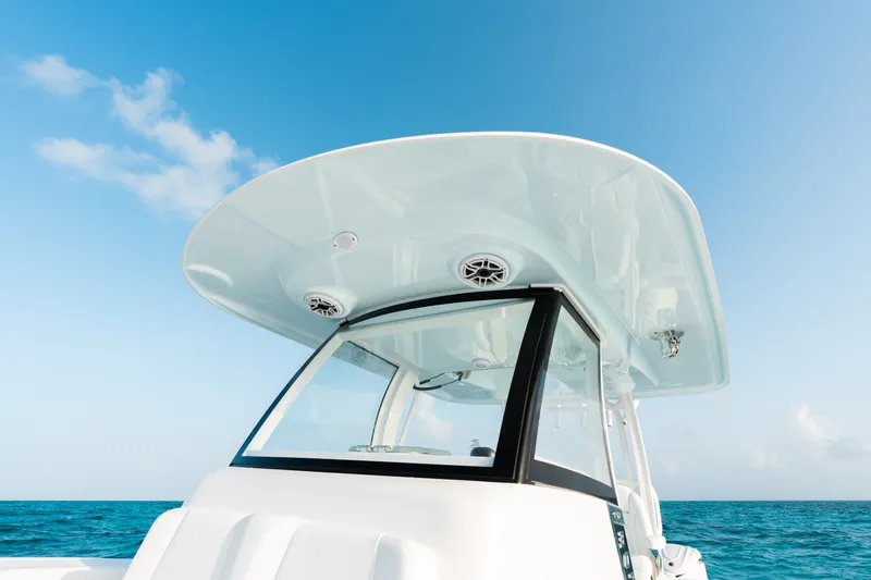 Slide: The Image of 2027 Sportsman Open 302 Center Console boat against clear blue sky and ocean. - 9
