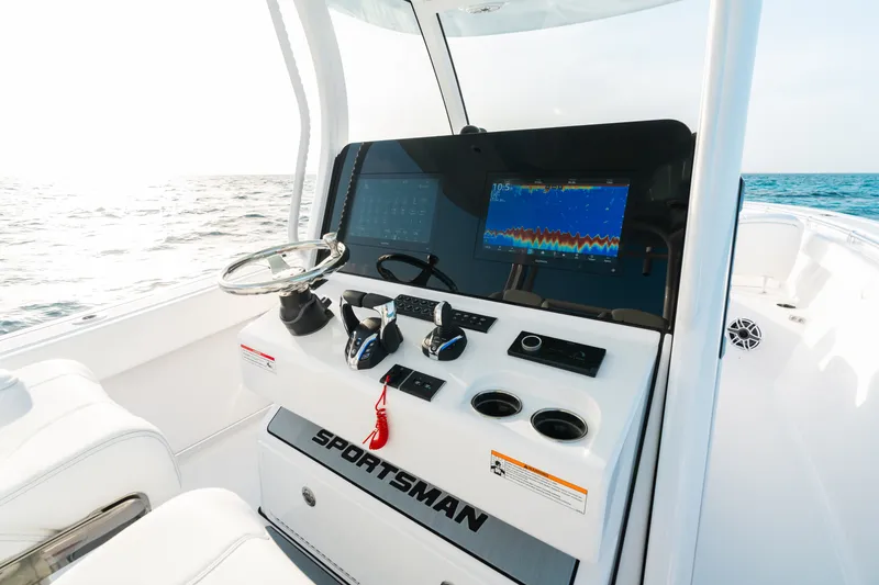 Slide: The Image of 2027 Sportsman Open 302 Center Console boat dashboard with navigation display on open sea. - 15