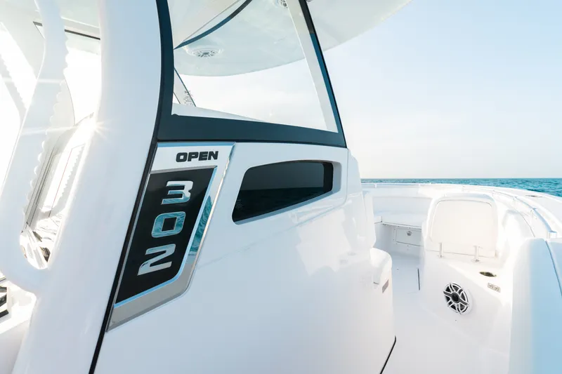 Slide: The Image of 2027 Sportsman Open 302 Center Console boat on open water, showcasing sleek design. - 11