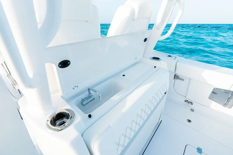 Slide: The Image of 2027 Sportsman Open 302 Center Console boat interior with sink, ocean view. - 21
