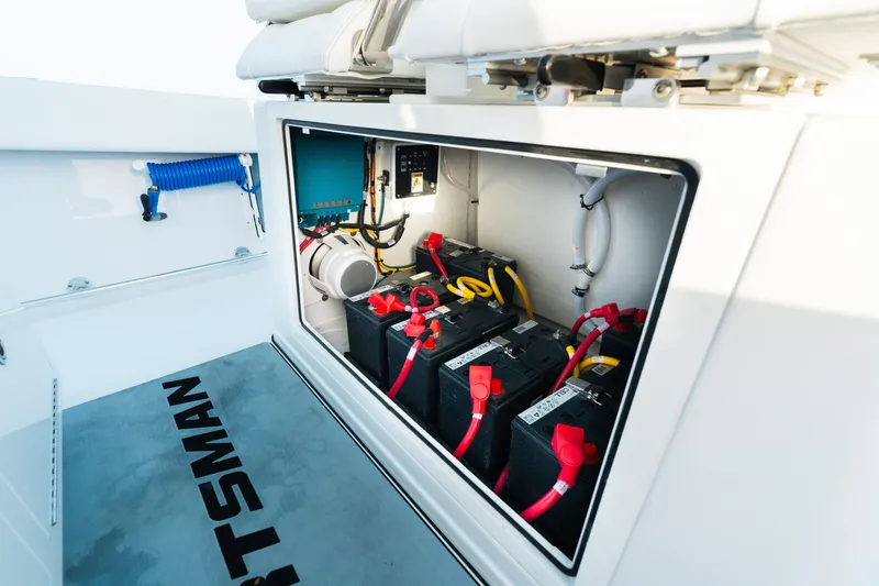 Slide: The Image of 2027 Sportsman Open 302 Center Console battery compartment with wiring and equipment. - 18
