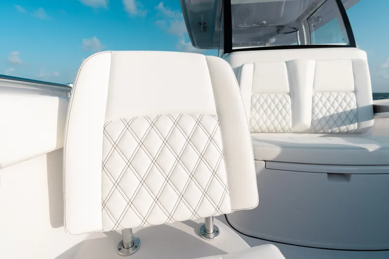 Slide: The Image of Luxurious seating on 2027 Sportsman Open 302 Center Console boat under clear blue sky. - 6