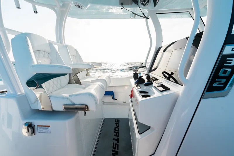 Slide: The Image of 2027 Sportsman Open 302 Center Console boat interior with luxurious seating and modern controls. - 14