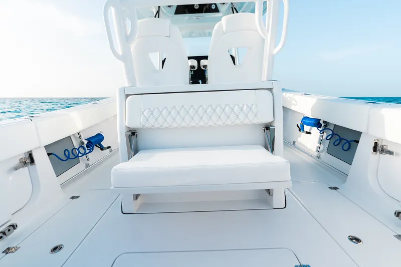 Slide: The Image of 2027 Sportsman Open 302 Center Console boat interior with white seating and ocean view. - 20
