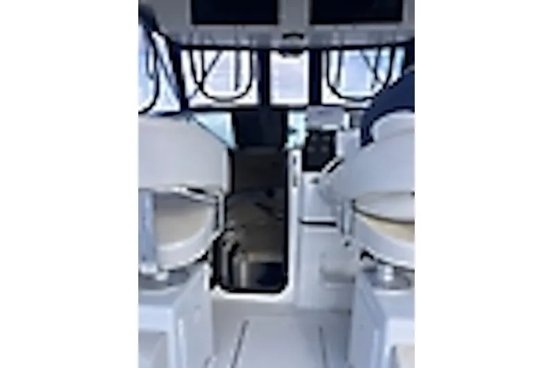 Slide: The Image of Interior view of a 2003 Triton 2690 WA boat cockpit with seating and controls. - 2