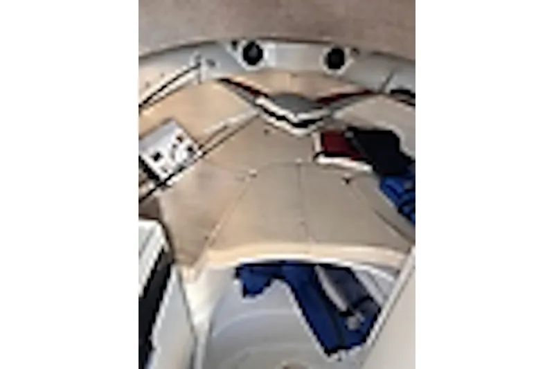 Slide: The Image of Interior view of 2003 Triton 2690 WA boat cabin with seating and storage. - 5