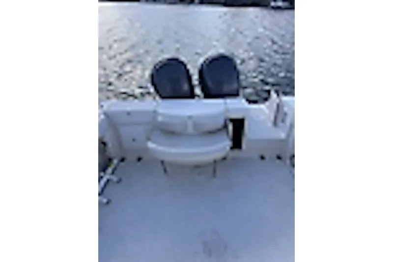 Slide: The Image of 2003 Triton 2690 WA boat deck with seating, overlooking calm water. - 4