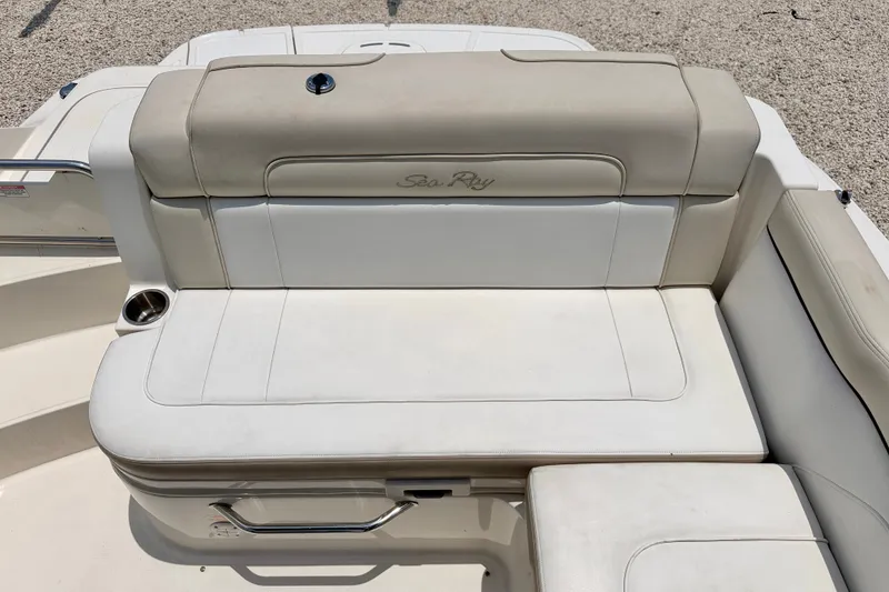 Slide: The Image of 2013 Sea Ray 260 Sundeck boat seating area with beige upholstery and cup holder. - 24