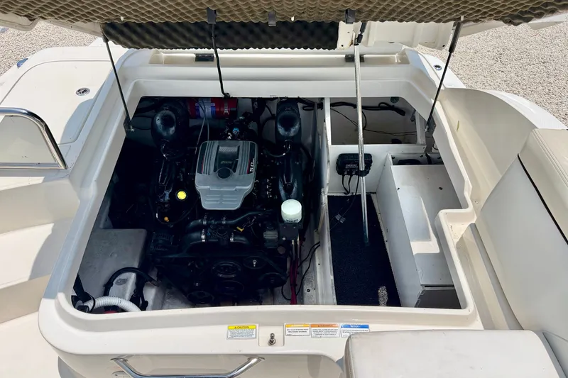 Slide: The Image of Engine compartment of a 2013 Sea Ray 260 Sundeck boat, showcasing the engine and interior layout. - 28