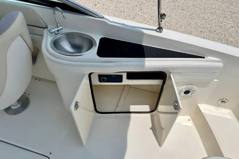 Slide: The Image of 2013 Sea Ray 260 Sundeck boat interior with sink and storage compartment. - 37