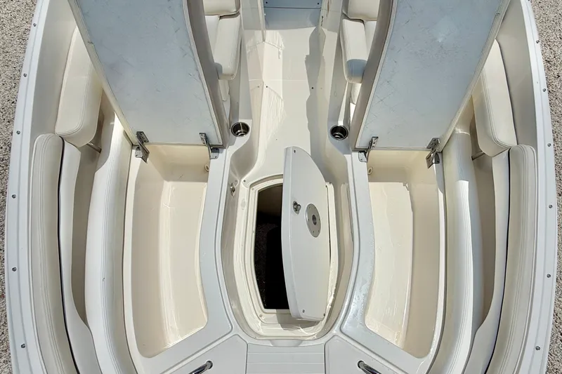 Slide: The Image of 2013 Sea Ray 260 Sundeck interior with open storage compartments and seating. - 34