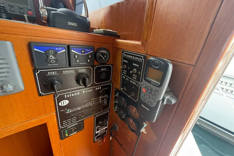 Slide: The Image of Control panel of a 2006 Island Pilot 395 boat with navigation and engine controls. - 21