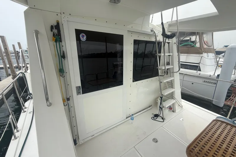 Slide: The Image of 2006 Island Pilot 395 yacht deck with ladder and docked boats in marina. - 10
