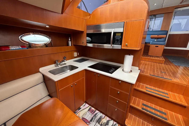 Slide: The Image of Luxurious 2006 Island Pilot 395 yacht interior with modern kitchen and wooden cabinetry. - 30