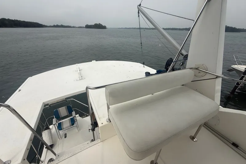 Slide: The Image of 2006 Island Pilot 395 yacht deck with seating, overlooking calm waters. - 14