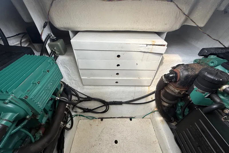 Slide: The Image of Engine room of a 2006 Island Pilot 395 boat, featuring mechanical components and wiring. - 47