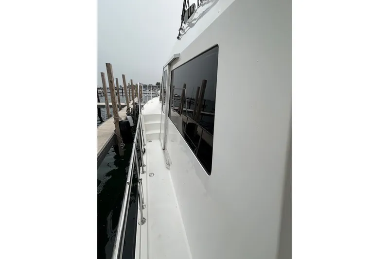Slide: The Image of Side view of 2006 Island Pilot 395 yacht docked at marina. - 6