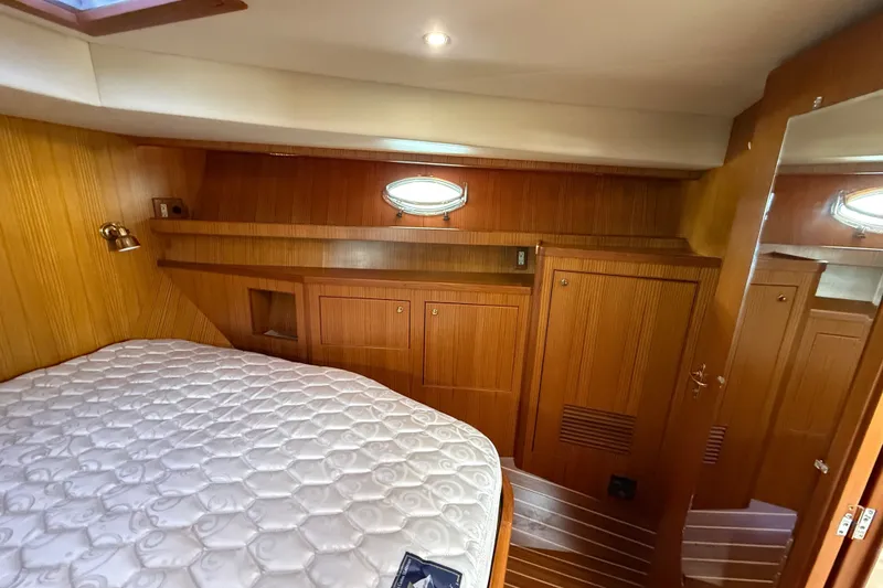 Slide: The Image of Cozy cabin interior of 2006 Island Pilot 395 with wood paneling and bed. - 41
