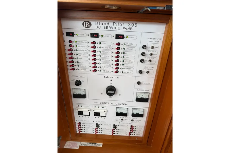 Slide: The Image of Island Pilot 395 DC service panel, 2006 model, featuring switches and controls. - 50
