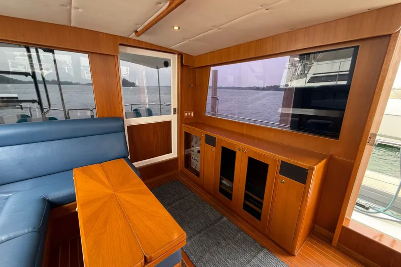 Slide: The Image of Luxurious interior of 2006 Island Pilot 395 yacht with wood finish and large window view. - 18