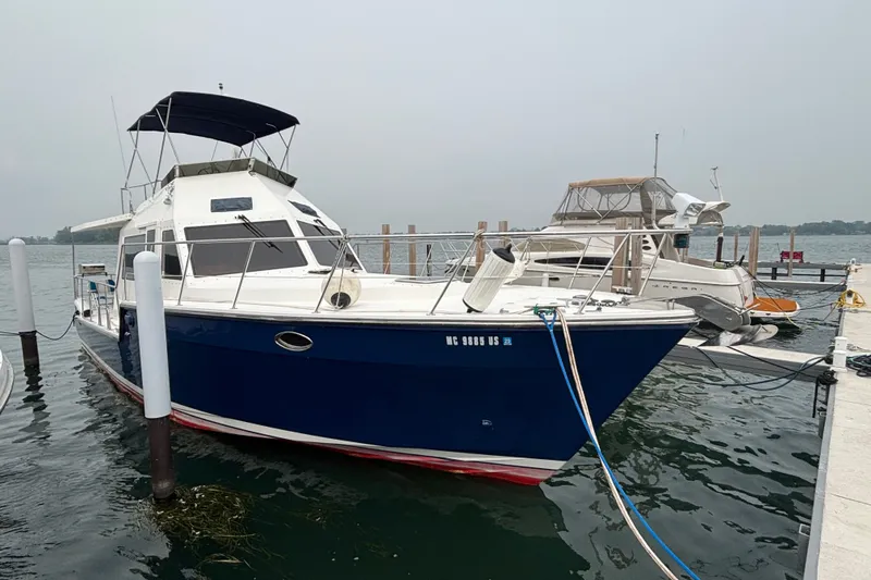 The Image of 2006 Island Pilot 395 boat docked at marina, featuring a sleek blue hull. - 0