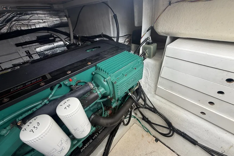 Slide: The Image of Engine compartment of a 2006 Island Pilot 395 boat, showcasing mechanical components. - 48