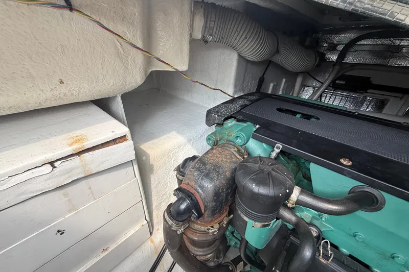 Slide: The Image of Engine compartment of a 2006 Island Pilot 395 boat, showing mechanical components and wiring. - 49