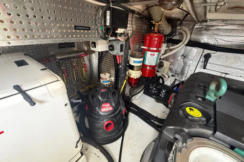 Slide: The Image of Engine room of a 2006 Island Pilot 395 with equipment and fire extinguisher. - 46