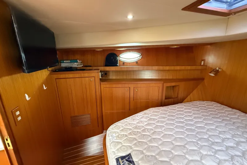 Slide: The Image of Cozy cabin interior of 2006 Island Pilot 395 with wood paneling and a comfortable bed. - 40