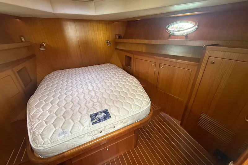 Slide: The Image of Luxurious cabin interior of 2006 Island Pilot 395 with wooden paneling and cozy bed. - 38