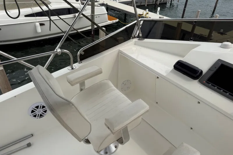 Slide: The Image of Captain's chair on 2006 Island Pilot 395 yacht, overlooking marina. - 13