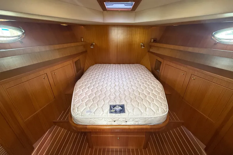 Slide: The Image of Luxurious 2006 Island Pilot 395 cabin with wood paneling and comfortable bed. - 37