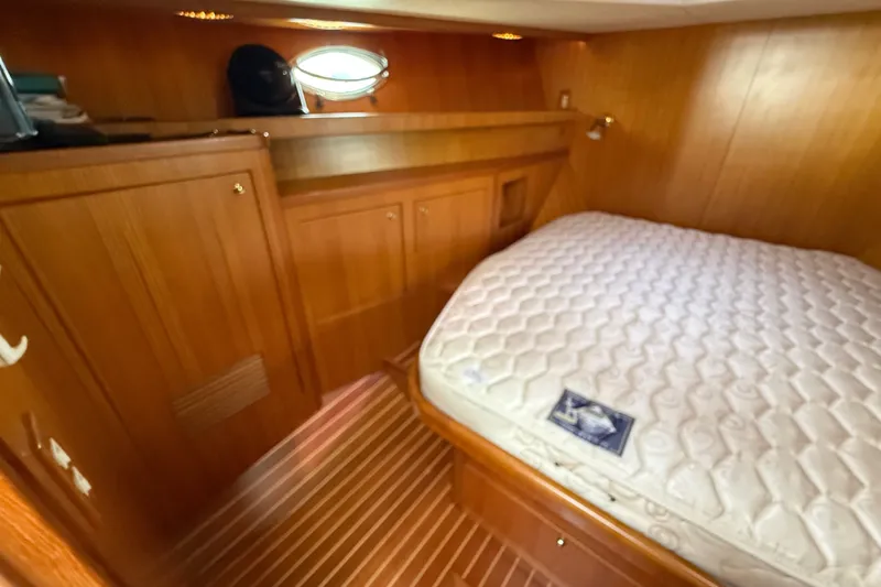 Slide: The Image of 2006 Island Pilot 395 cabin with wooden interior and comfortable bed. - 39