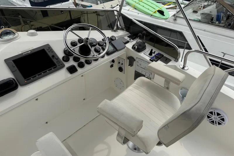 Slide: The Image of Helm of 2006 Island Pilot 395 boat with steering wheel and navigation controls. - 12