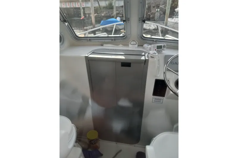 Slide: The Image of Interior view of 2022 May-Craft 2300 Pilot House boat cockpit with navigation equipment. - 7