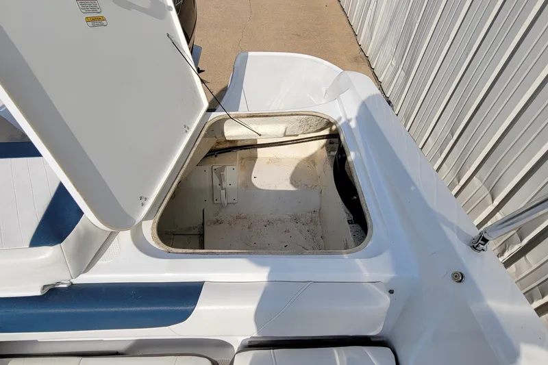 Slide: The Image of Open storage compartment on a 2022 Tahoe 185 S boat, showing interior space. - 21