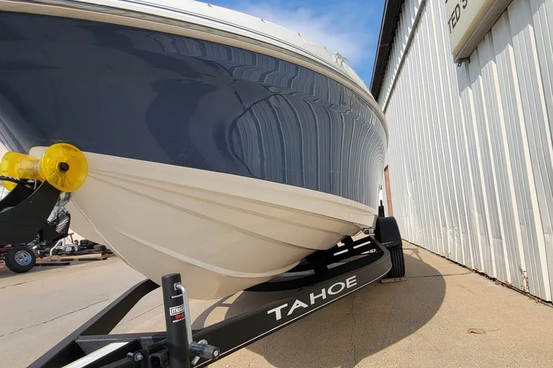 Slide: The Image of 2022 Tahoe 185 S boat on trailer beside a white building. - 15