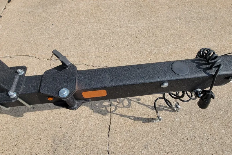 Slide: The Image of Trailer hitch of a 2022 Tahoe 185 S boat on concrete surface. - 13