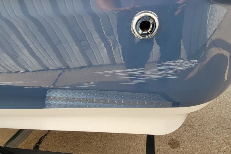 Slide: The Image of 2022 Tahoe 185 S boat hull with visible scratches and metal fitting. - 17