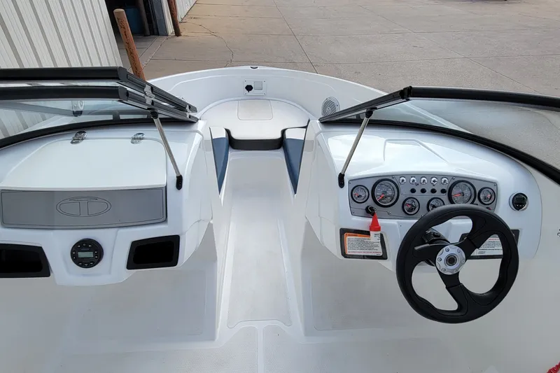 Slide: The Image of 2022 Tahoe 185 S boat dashboard with steering wheel and control gauges. - 30