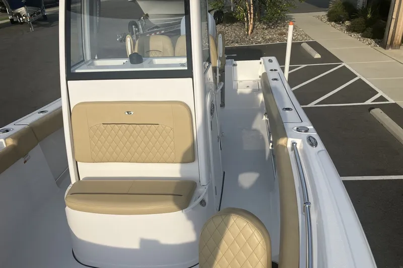 Slide: The Image of 2024 Sportsman Open 232 Center Console boat with beige seating and sleek design. - 16