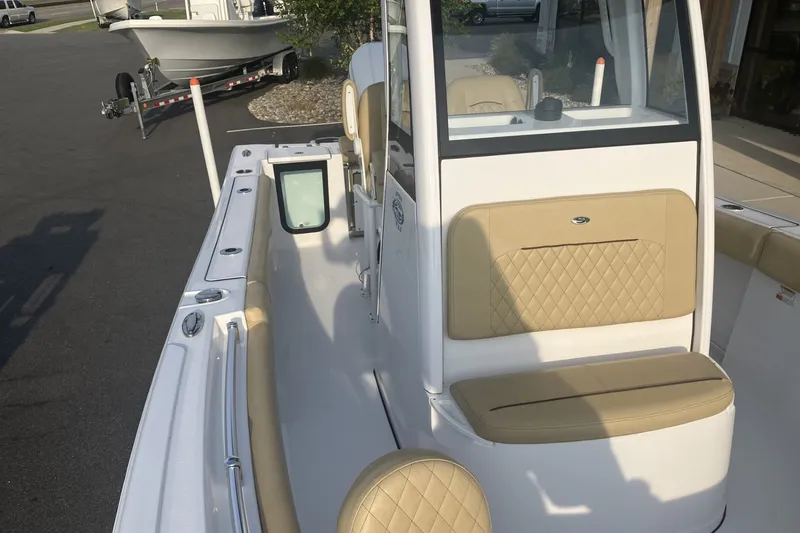 Slide: The Image of 2024 Sportsman Open 232 Center Console boat with beige seating and sleek design. - 15