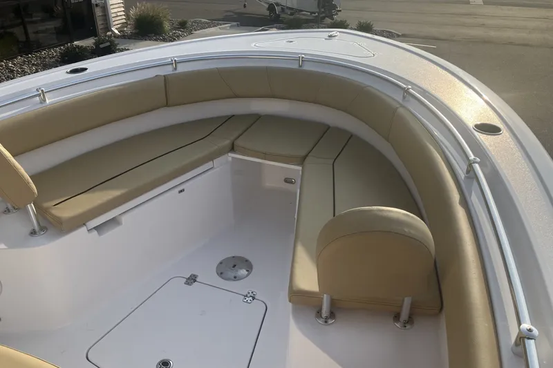 Slide: The Image of 2024 Sportsman Open 232 Center Console boat with tan cushioned seating. - 18