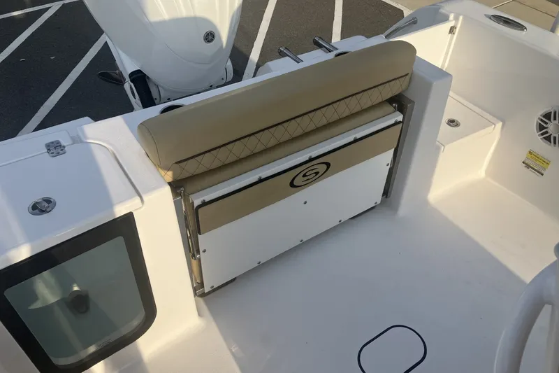 Slide: The Image of 2024 Sportsman Open 232 Center Console boat interior with seating and storage. - 14