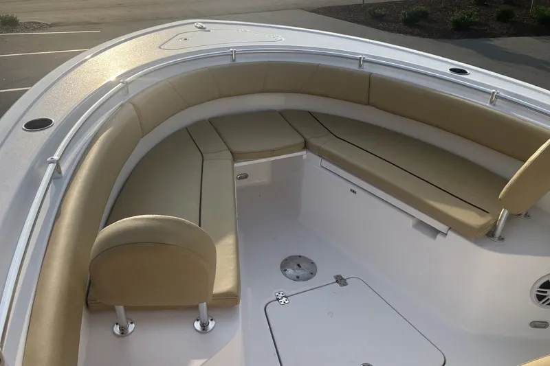 Slide: The Image of 2024 Sportsman Open 232 Center Console boat with tan cushioned seating area. - 19