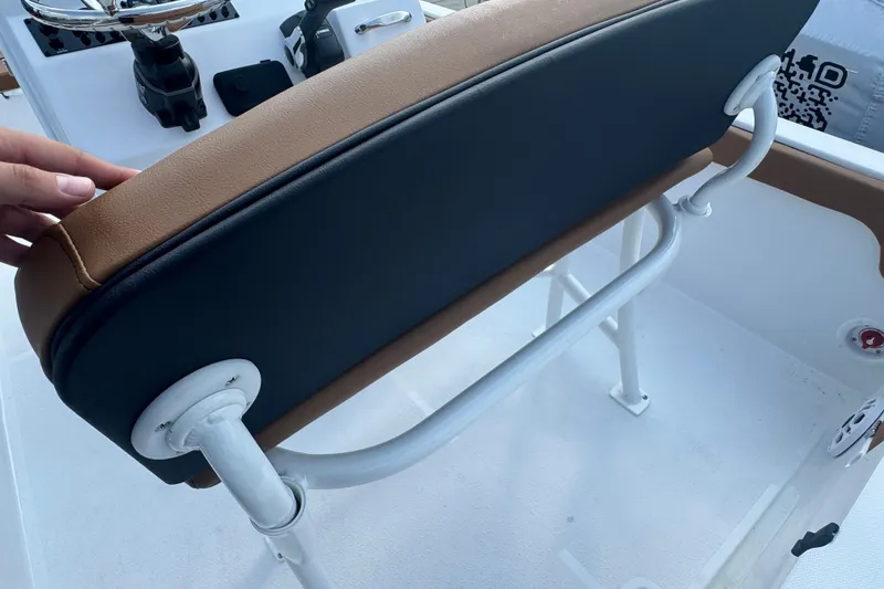 Slide: The Image of 2027 Stingray 17 CC boat seat with brown and black upholstery, white frame. - 6